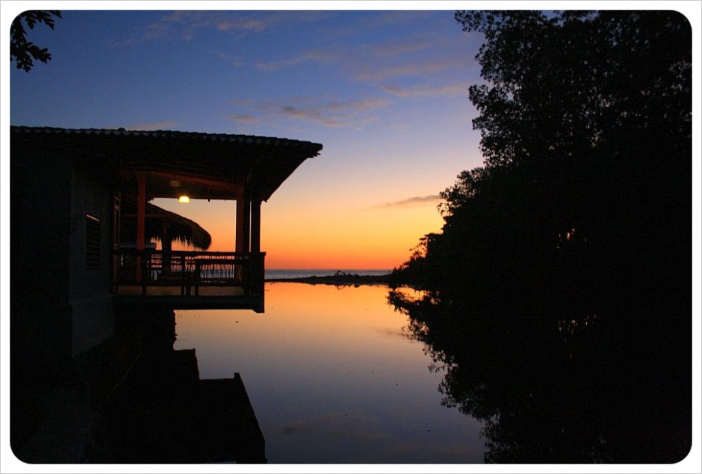 Sunset over river flowing into Pacific at El Tunco, El Salvador El Tunco, El Salvador